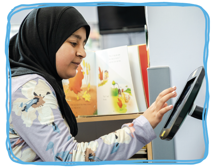 girl playing on a digital screen in the children's department reception area