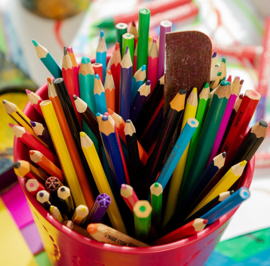 pot of colourful pencil crayons and felt-tip pens