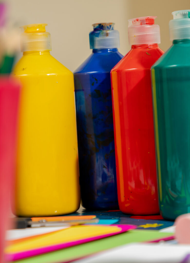 large bottles of colourful paint