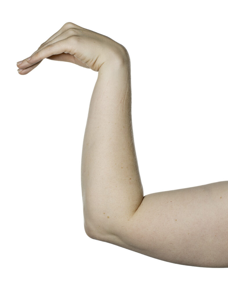 Exercise shows forearm supported on a table with hand raised and wrist bent downwards.