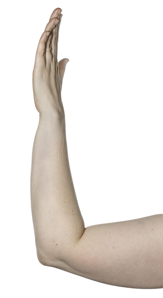 Picture shows elbow resting on a table, hand raised with straight fingers