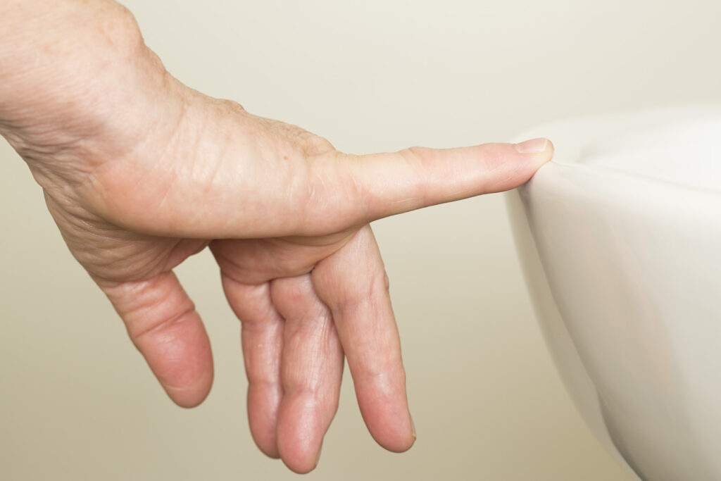 Picture shows tip of finger resting on edge of wash basin